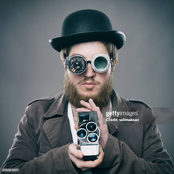 bearded man with his old fashioned smart glasses holding camera - steampunk stockfoto's en -beelden