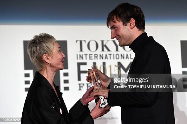 Slovenia's film director Olmo Omerzu receives the Best Artistic Contribution Award trophy for his film "Family Film" from Hong Kong film producer and...