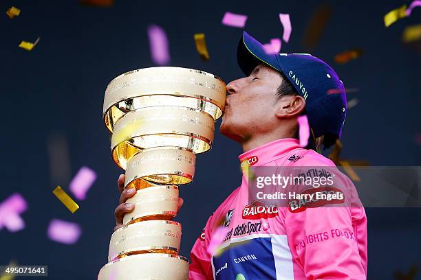 Nairo Quintana of Colombia and team Movistar kisses the winners trophy, the 'Trofeo Senza Fine', following the twenty-first stage of the 2014 Giro...