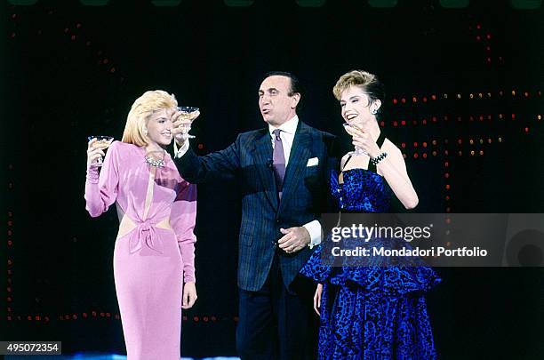 The showgirl Lorella Cuccarini , the TV presenter Pippo Baudo (Giuseppe Raimondo Vittorio Baudo, and the actress dancer Alessandra Martines raising...