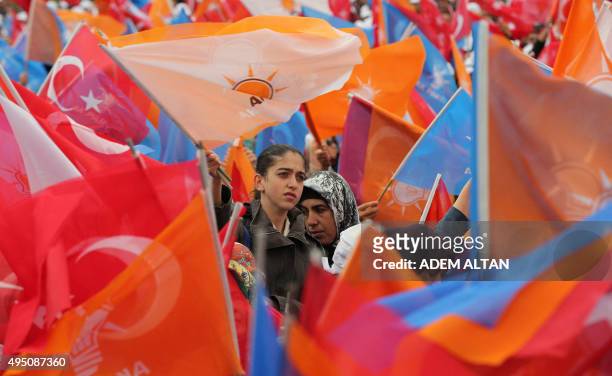 Supporters listen to Turkish Prime Minister and Justice and Development party leader during an election campaign rally in Ankara, Turkey on October...
