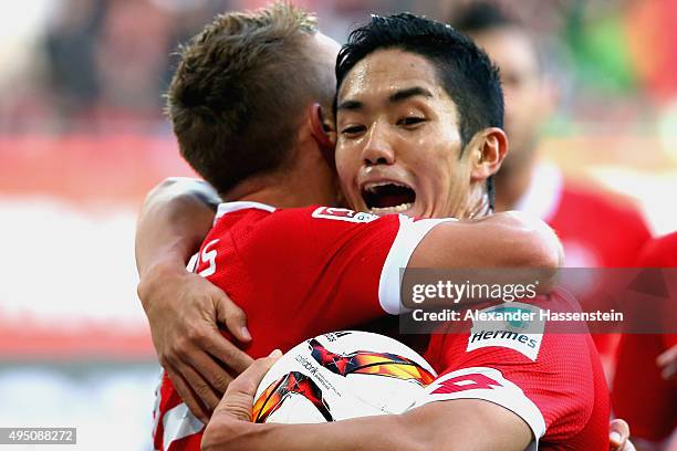 Yoshinori Muto of Mainz celebrates scoring the opening goal with his team mate Pablo De Blasis during the Bundesliga match between FC Augsburg and 1....