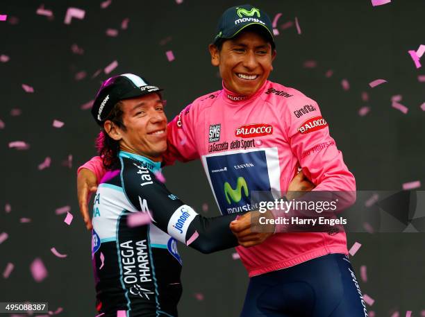 Nairo Quintana of Colombia and team Movistar embraces fellow Colombian Rigoberto Uran of team Omega Pharma-QuickStep following the twenty-first stage...