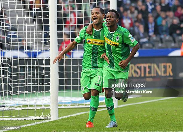 Raffael of Moenchengladbach jubilates with team mate Ibrahima Traore after scoring the second goal during the Bundesliga match between Hertha BSC and...