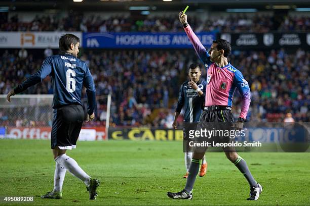 Referee César Arturo Ramos shows a yellow card to Juan Forlin of Querétaro during the 15th round match between Queretaro and Monterrey as part of the...
