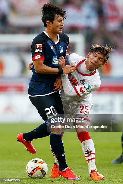 Kazuki Nagasawa of koeln battles for the ball with Kim Jin-su of Hoffenheim during the Bundesliga match between 1. FC Koeln and TSG 1899 Hoffenheim...