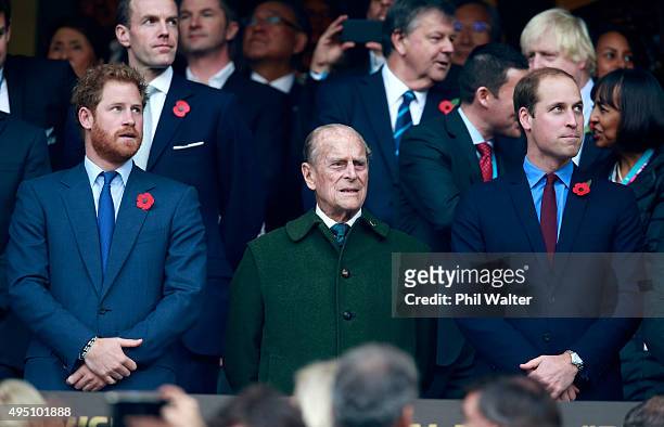 Prince Harry, Prince Phillip and Prince William stand for the national anthems at to the 2015 Rugby World Cup Final match between New Zealand and...