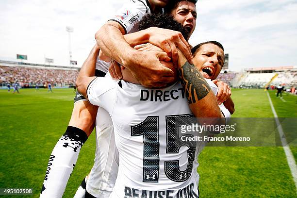 Jean Beausejour of Colo Colo celebrates with teammates after scoring the opening goal during a match between U de Chile and Colo-Colo as a part of 11...