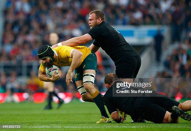 Scott Fardy of Australia is tackled by Owen Franks of New Zealand and Joe Moody of New Zealand during the 2015 Rugby World Cup Final match between...