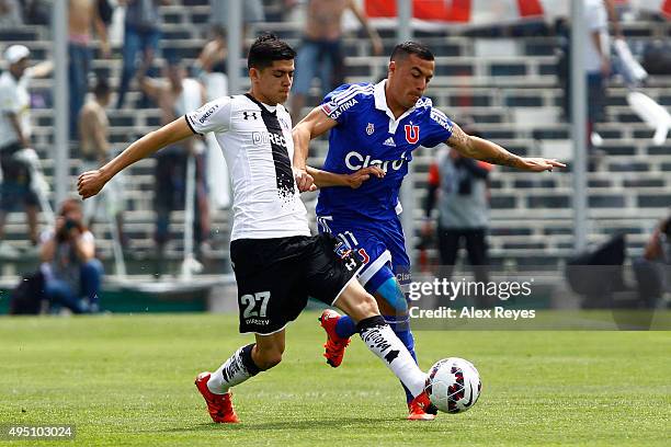 Cristian Gutierrez of Colo Colo fights for the ball with Sebastian Ubilla of U de Chile during a match between Colo Colo and U de Chile as part of...