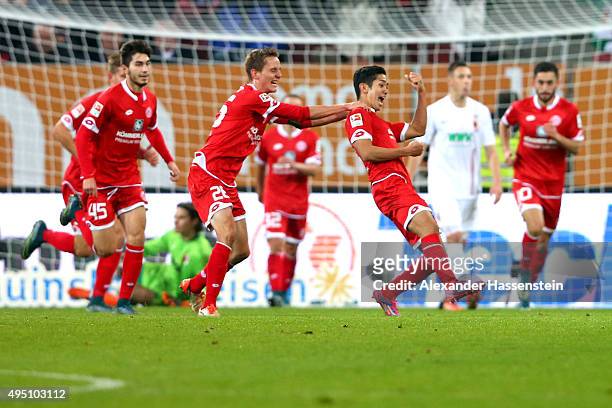 Yoshinori Muto of Mainz celebrates scoring the 3rd team goal during the Bundesliga match between FC Augsburg and 1. FSV Mainz 05 at WWK Arena on...