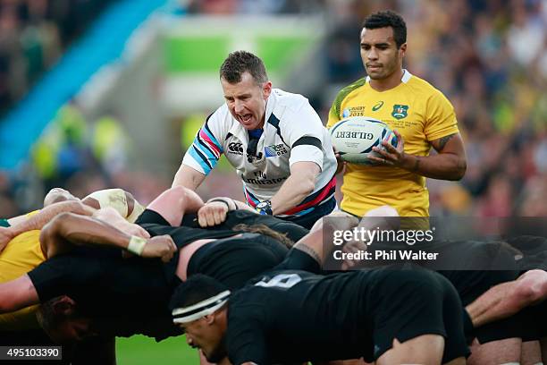 Will Genia of Australia prepares to put the ball into the scrum as referee Nigel Owens of Wales sets the two packs during the 2015 Rugby World Cup...