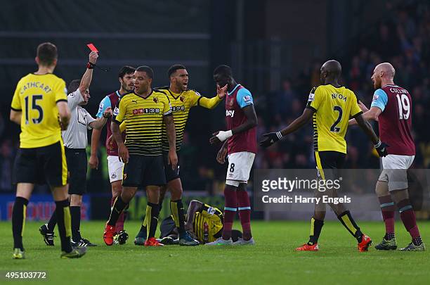 James Collins of West Ham United is shown a red card by referee Keith Stroud during the Barclays Premier League match between Watford and West Ham...
