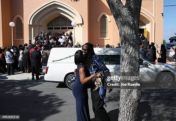 Samantha Barber and Anthony Banks hug as they arrive for the funeral of Corey Jones at the Payne Chapel AME church on October 31, 2015 in West Palm...