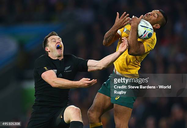 Kurtley Beale of Australia wins a high ball from Ben Smith of the New Zealand All Blacks during the 2015 Rugby World Cup Final match between New...