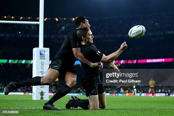 Beauden Barrett of New Zealand celebrates scoring his team's third try with team-mate Julian Savea of New Zealand during the 2015 Rugby World Cup...