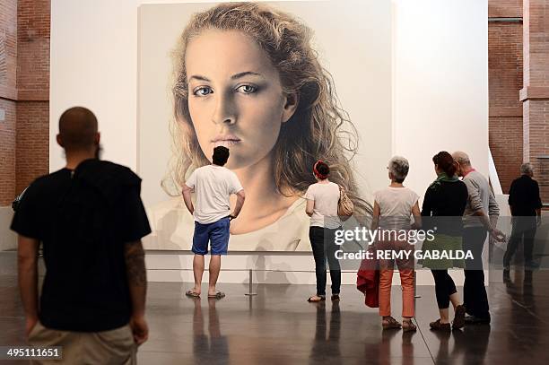 Visitors look at a monumental painting by Swiss artist Franz Gertsch in the Abattoirs Museum in Toulouse, southern France, as part of Toulouse's...