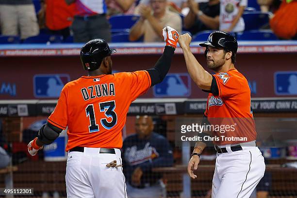 Marcell Ozuna of the Miami Marlins celebrates a two run homer in the second inning to score teammate Garrett Jones of the Miami Marlins against the...