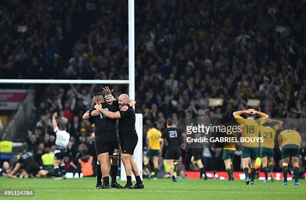 New Zealand's prop Charlie Faumuina, New Zealand's number 8 Kieran Read and New Zealand's prop Joe Moody celebrate after their third try during the...