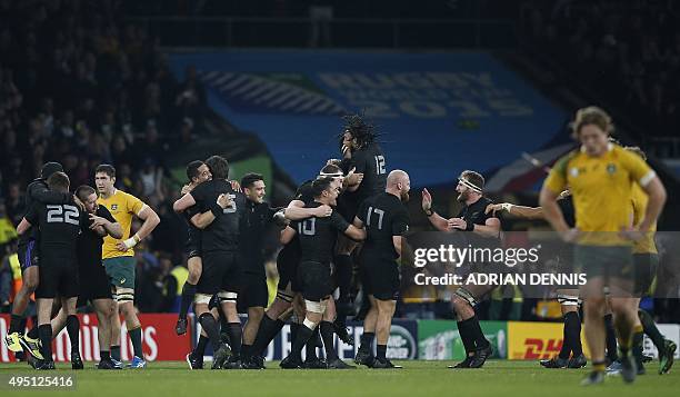 New Zealands players celebrate at the final whistle after winning 34-17 during the final match of the 2015 Rugby World Cup between New Zealand and...