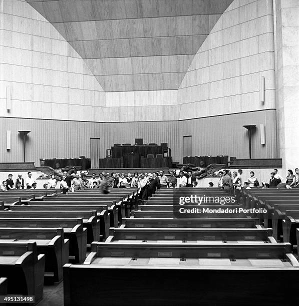 Some people waiting in a hall of the United Nations Office at Geneva before the Summit to discuss global security, German unification and...