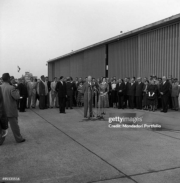 American politician and president of the United States Dwight D. Eisenhower speaking into the microphones beside his wife Mamie Geneva Doud at the...