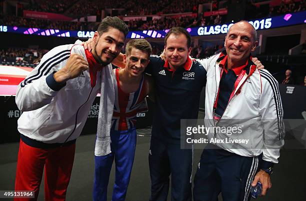 Louis Smith and Max Whitlock of Great Britain celebrate with coaches Scott Hann and Eddie Van Hoof after winning Gold and Silver in the Pommel Horse...