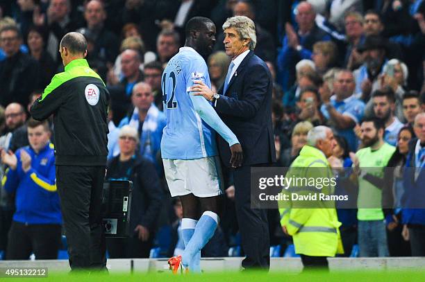 Yaya Toure of Manchester City FC talks with his Head Coach Manuel Pellegrini of as he is being substituted during the Barclays Premier League match...