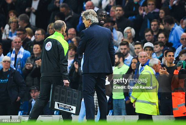 Yaya Toure of Manchester City FC talks with his Head Coach Manuel Pellegrini of as he is being substituted during the Barclays Premier League match...