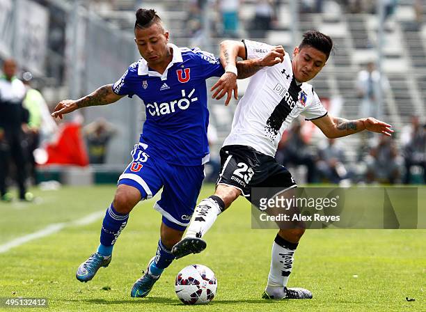 Leonardo Valencia of U de Chile fights for the ball with Cristian Gutierrez of Colo Colo during a match between Colo Colo and U de Chile as part of...