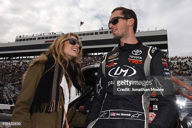 Ben Kennedy, driver of the Local Motors Toyota, and his girlfriend Chelsea Saunders stand on the grid during pre-race ceremonies for during the...