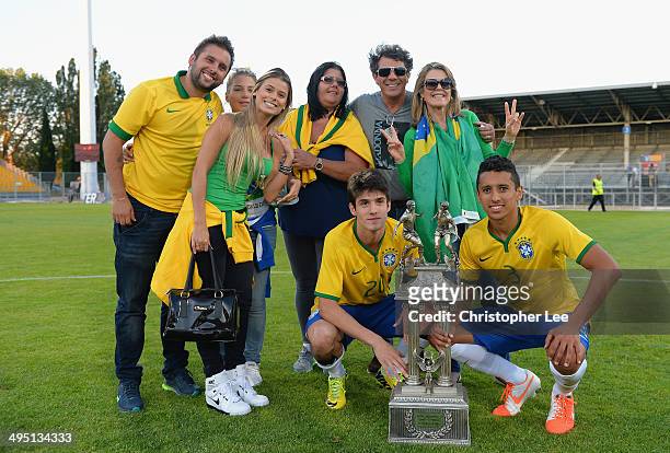Lucas Piazon and Marquinhos of Brazil pose for the camera's with their friends and Families as they celebrate their victory with the trophy during...