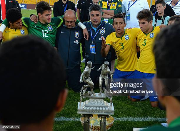 Marquinhos of Brazil with coach Alexandre Gallo gives a speech to his team mates as they all take it in turns to say something as the players and...