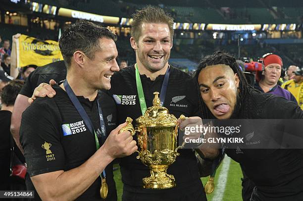 New Zealand's fly half Dan Carter , New Zealand's flanker and captain Richie McCaw and New Zealand's centre Ma'a Nonu celebrate with the Webb Ellis...