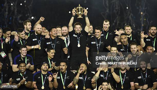 New Zealand's flanker and captain Richie McCaw holds the Webb Ellis Cup as he celebrates with teammates after winning the final match of the 2015...