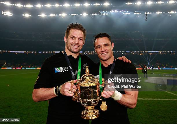 Richie McCaw of New Zealand and Dan Carter of New Zealand pose with the Webb Ellis Cup after victory in the 2015 Rugby World Cup Final match between...