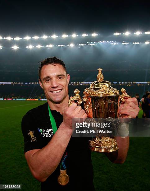 Dan Carter of New Zealand poses with the Webb Ellis Cup after victory in the 2015 Rugby World Cup Final match between New Zealand and Australia at...
