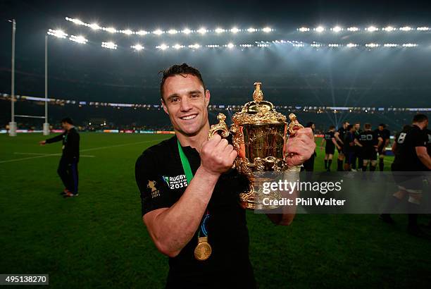 Dan Carter of New Zealand poses with the Webb Ellis Cup after victory in the 2015 Rugby World Cup Final match between New Zealand and Australia at...