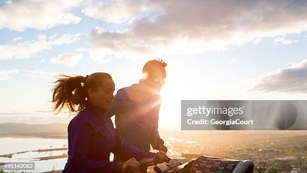 baby's first sunrise run - jogging stroller stockfoto's en -beelden