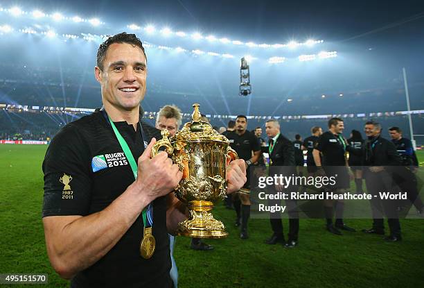 Dan Carter of the New Zealand All Blacks poses with the Webb Ellis Cup following the victory against Australia in the 2015 Rugby World Cup Final...