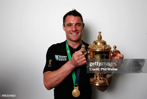 Dan Carter of New Zealand poses with the Webb Ellis Cup in the dressing rooms following victory in the 2015 Rugby World Cup Final match between New...