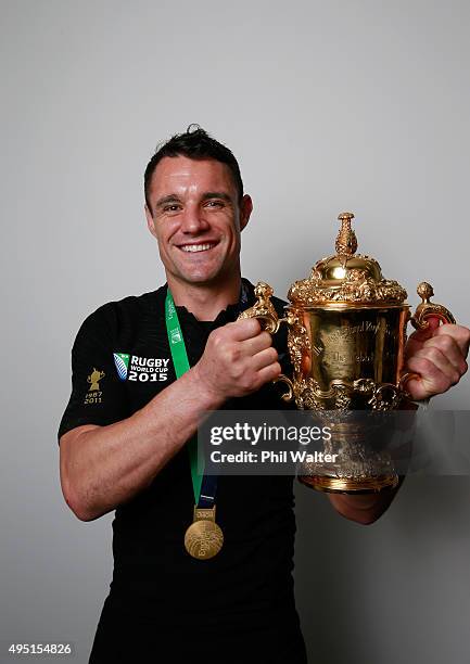 Dan Carter of New Zealand poses with the Webb Ellis Cup in the dressing rooms following victory in the 2015 Rugby World Cup Final match between New...