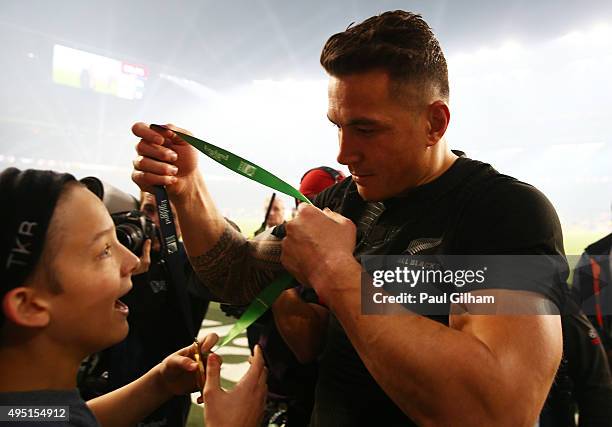 Sonny Bill Williams of New Zealand gives his winning medal to young fan Charlie Lines following the 2015 Rugby World Cup Final match between New...