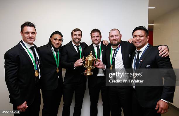 Dan Carter, Ma'a Nonu, Conrad Smith, Richie McCaw, Owen Franks and Keven Mealamu of New Zealand celebrate with the Webb Ellis Cup in the dressing...