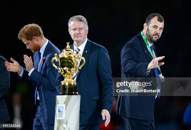 Michael Cheika the head coach of Australia passes by the Webb Ellis Cup as Prince Harry and Bernard Lapasset, World Rugby Chairman, applaud his team...