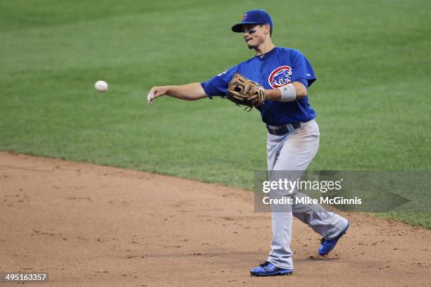 Darwin Barney of the Chicago Cubs makes the throw to first base to retire Mark Reynolds in the bottom of the fifth inning against the Milwaukee...