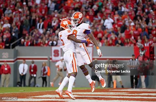 Deon Cain of the Clemson Tigers celebrates catching a touchdown pass with teammate Germone Hopper during their game against the North Carolina State...