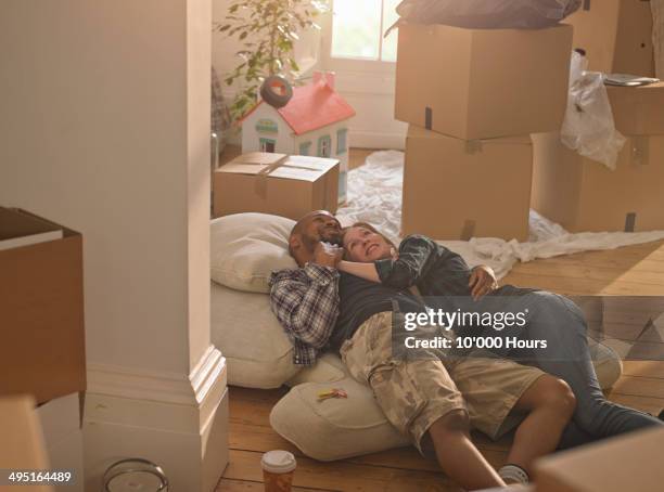 a happy excited couple in their new home - life events foto e immagini stock