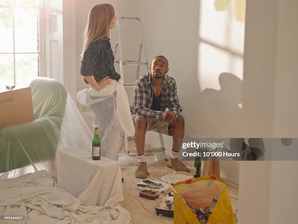 Couple taking a break from doing DIY in new home