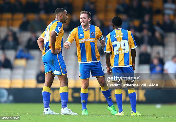 Liam Lawrence of Shrewsbury Town gives instructions to Tyrone Barnett and Larnell Cole of Shrewsbury Town during the Sky Bet League One match between...